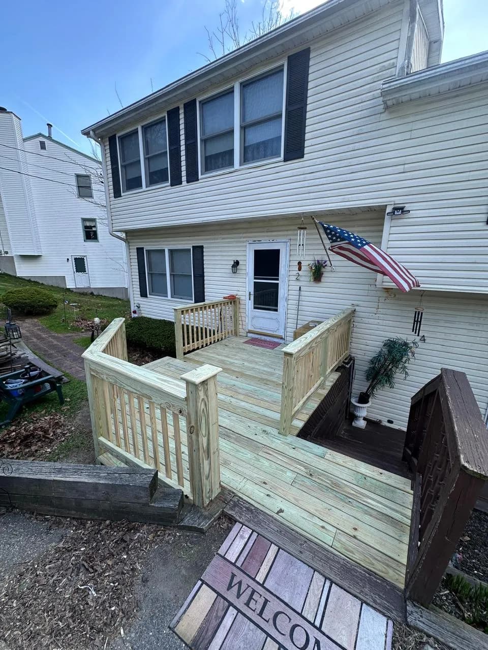 Pressure-treated entry deck wrapping the front of a home