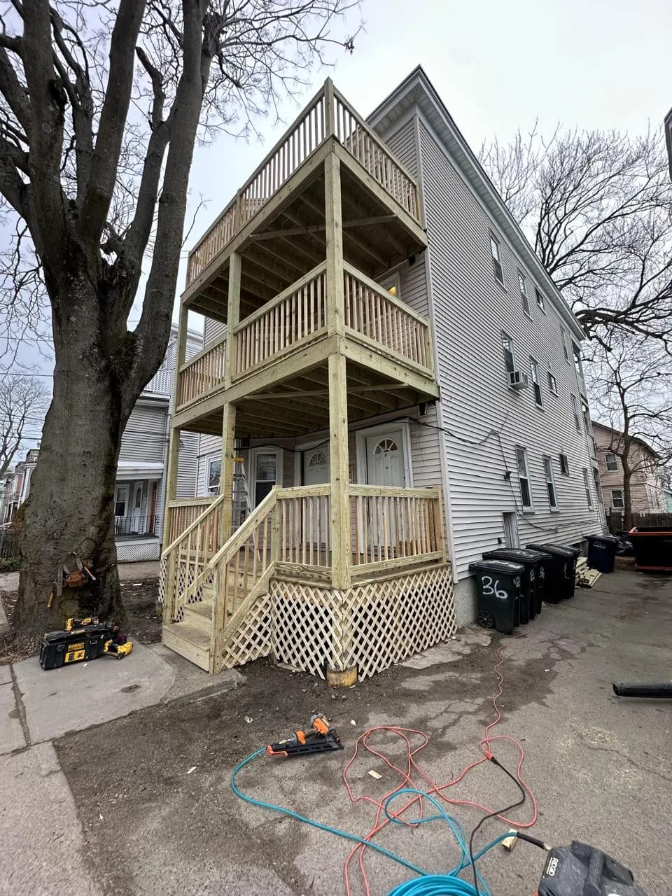 Three-story pressure-treated deck and stair system under construction