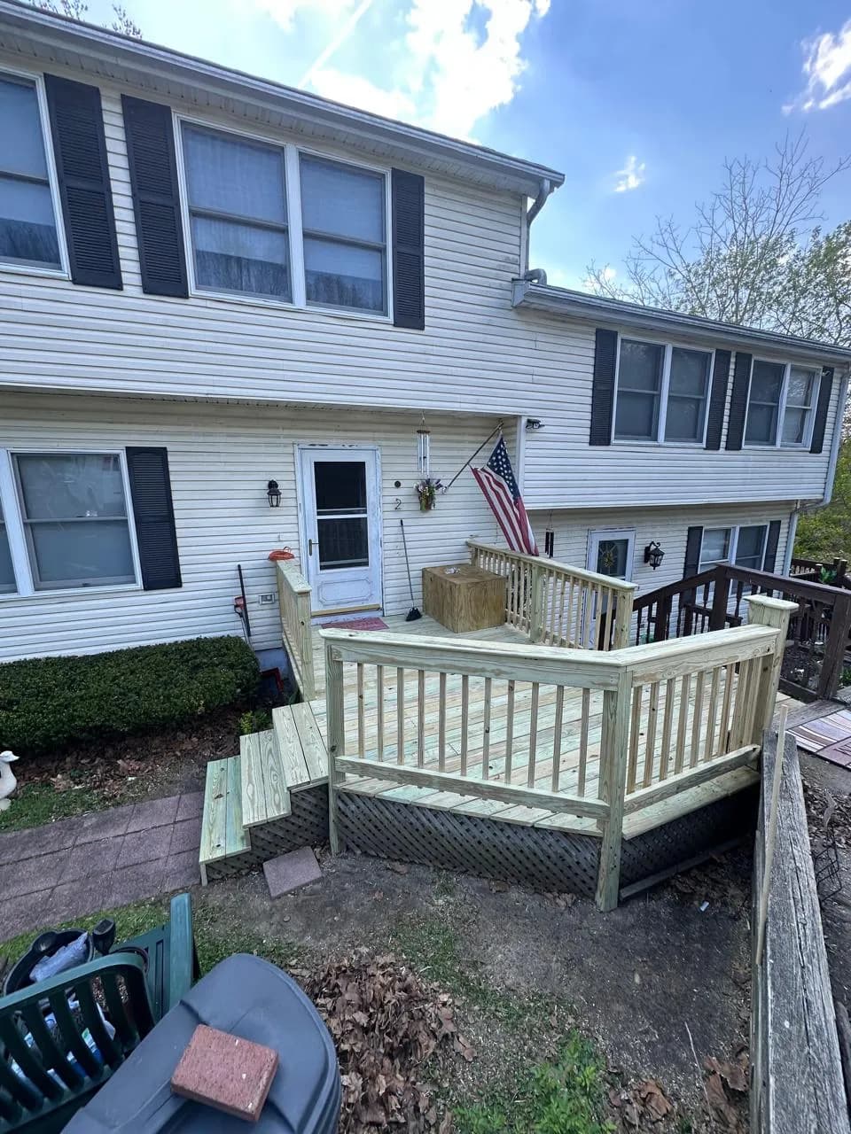 New pressure-treated front deck with railings and steps