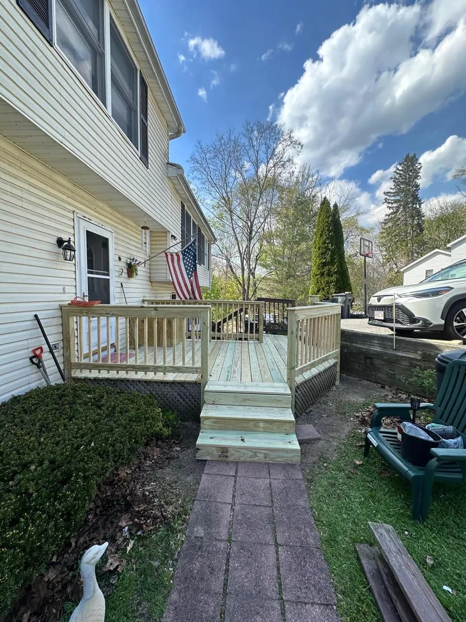 Pressure-treated side deck with steps down to a brick walkway