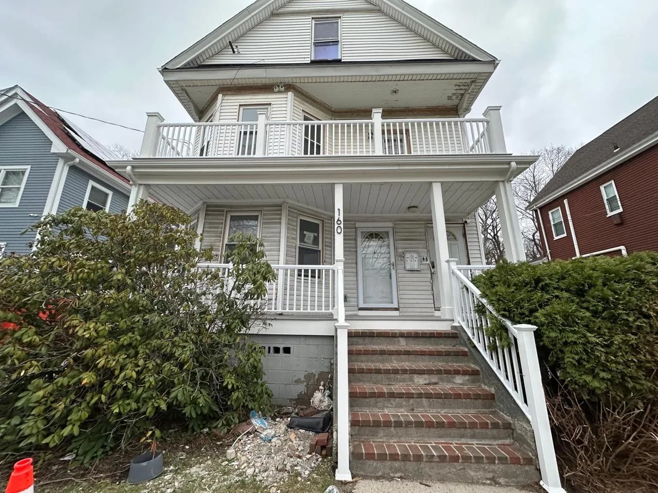 Multi-family home with rebuilt front porches and railings